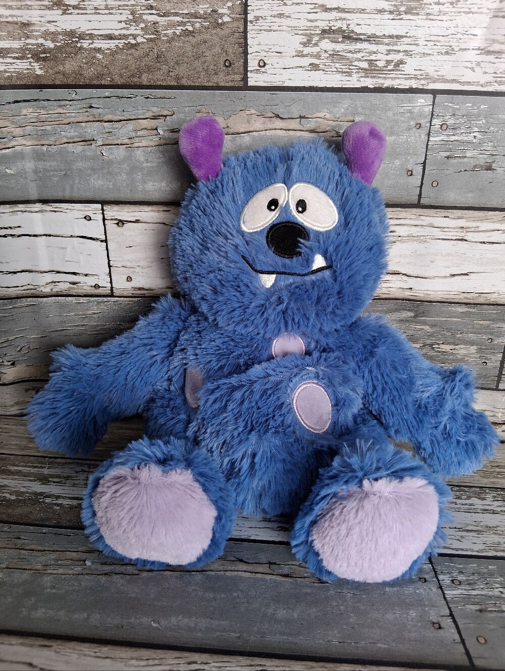 Warmies Blue Plush Monster Stuffed Animal  with Purple Accents - Cozy Cuddly Toy
